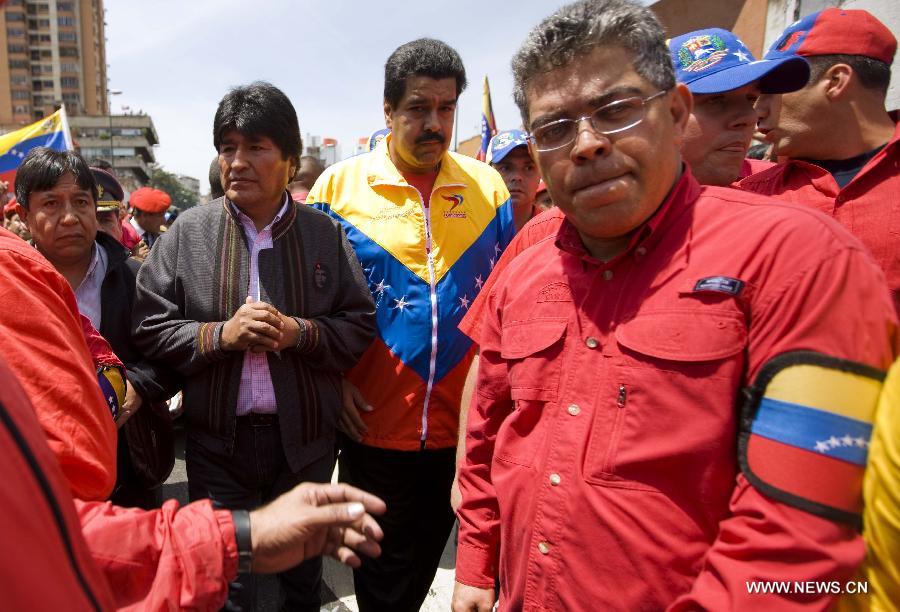 Venezuelan Vice President Nicolas Maduro (C), Bolivian President Evo Morales (2nd L) and Venezuelan Foreign Minister Elias Jaua (R) participate in the funeral procession in honor of Venezuelan President Hugo Chavez on the streets of Caracas, capital of Venezuela, on March 6, 2013. On Tuesday afternoon, Venezuelan President, Hugo Chavez, died after fighting for almost two years with a cancer disease. The body of Chavez is moved from the health center to the Military Academy in southern Caracas, inside Tiuna's Fort. (Xinhua/David de la Paz)