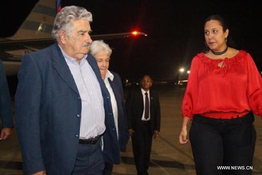 Image provided by People's Ministry of Foreign Affairs of Venezuela, shows Uruguayan President Jose Mujica (L) arriving at Caracas city, capital of Venezuela, on March 6, 2013. Venezuelan President Hugo Chavez died of cancer on Tuesday. (Xinhua/People's Ministry of Foreign Affairs of Venezuela)