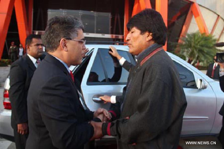 Image provided by People's Ministry of Foreign Affairs of Venezuela, shows Bolivian President Evo Morales (R) greeting the Venezuelan Foreign Minister Elias Jaua (L) upon his arrival in Caracas city, capital of Venezuela, on March 6, 2013. Venezuelan President Hugo Chavez died of cancer on Tuesday. (Xinhua/People's Ministry of Foreign Affairs of Venezuela)
