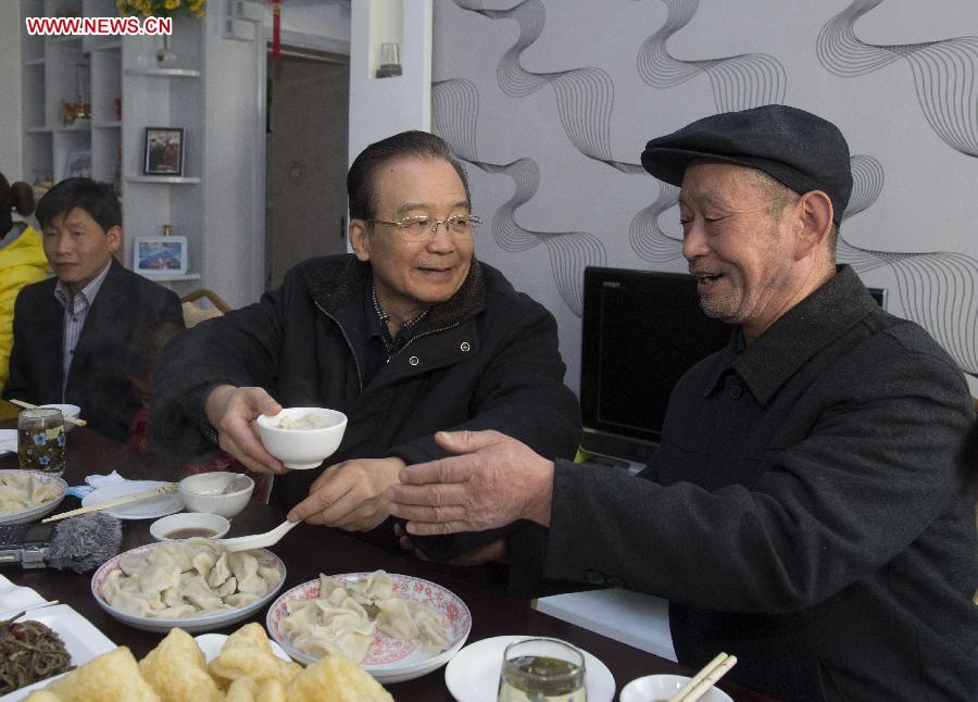 Chinese Premier Wen Jiabao (2nd R) has dumplings with local residents in Zhouqu County, northwest China's Gansu Province, Feb. 9, 2013. Premier Wen made an inspection tour in Gansu and Shaanxi Province, also in northwest China, on Feb. 8-9. (Xinhua File Photo/Li Xueren)