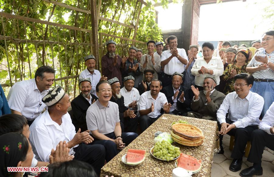 Chinese Premier Wen Jiabao (4th L, front) meets with villagers at a village in Kashgar, northwest China's Xinjiang Uygur Autonomous Region, Sept. 4, 2012. Premier Wen has stressed during his inspection tour of Xinjiang from Sept. 3 to 5 that promoting leapfrog development in the area is key to its long-term stability. (Xinhua File Photo/Li Xueren)