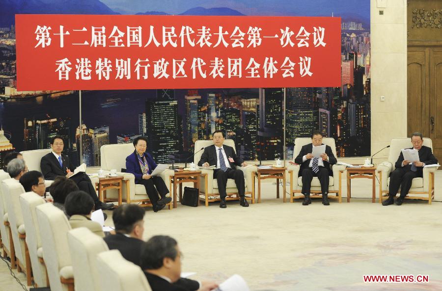 Zhang Dejiang (3rd R), a member of the Standing Committee of the Political Bureau of the Communist Party of China (CPC) Central Committee, joins a discussion with deputies from south China's Hong Kong Special Administrative Region, who attend the first session of the 12th National People's Congress (NPC), in Beijing, capital of China, March 7, 2013. (Xinhua/Xie Huanchi)
