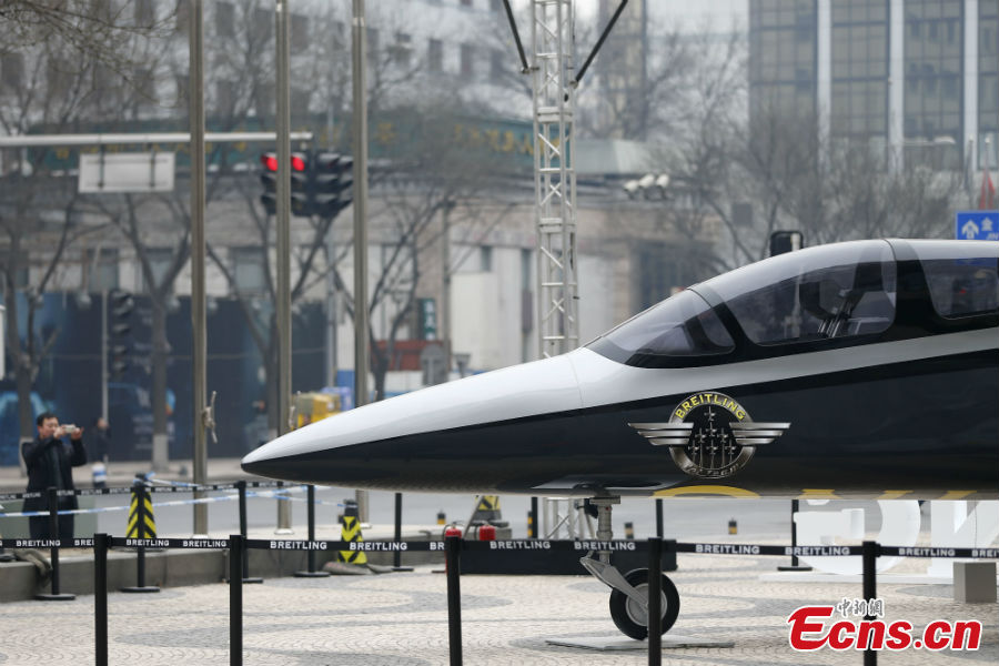 A full-size fighter jet model is put on display to mark the opening of a watch store at the Wangfujing Street in Beijing, March 6, 2013. (CNS/Fu Tian)
