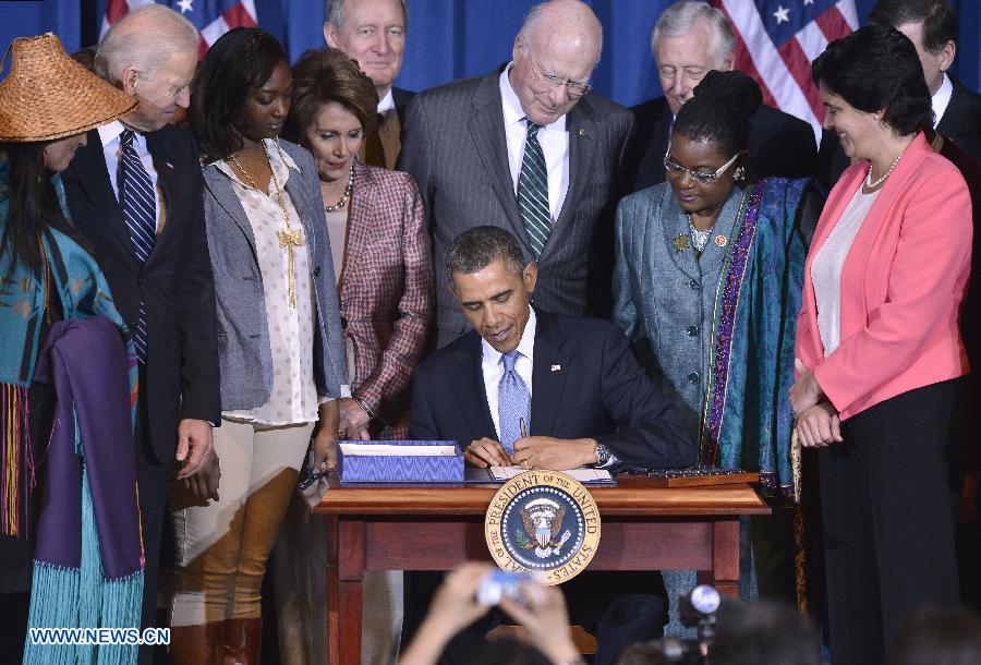 U.S. President Barack Obama (C) signs the Violence Against Women Act into law at the Department of the Interior in Washington D.C., capital of the United States, March 7, 2013. (Xinhua/Zhang Jun) 