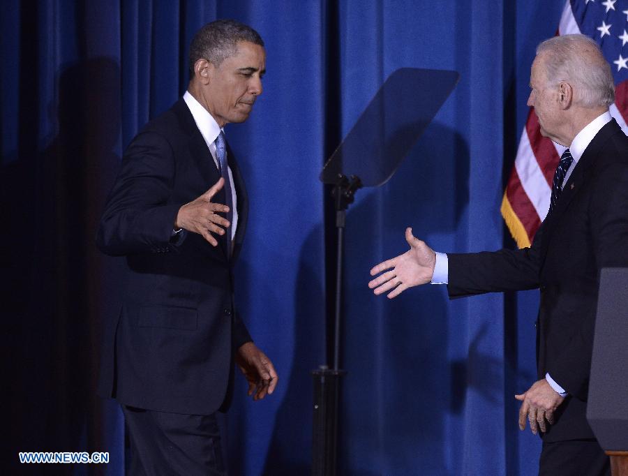 U.S. President Barack Obama (L) shakes hands with Vice President Joe Biden before signing the Violence Against Women Act into law at the Department of the Interior in Washington D.C., capital of the United States, March 7, 2013. (Xinhua/Zhang Jun) 