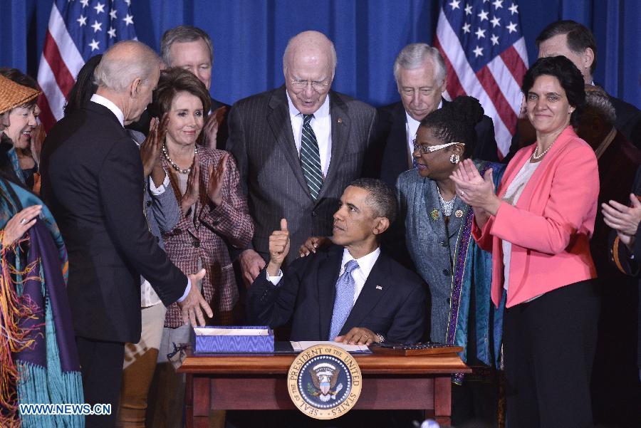 U.S. President Barack Obamas (C) gestures after signing the Violence Against Women Act into law at the Department of the Interior in Washington D.C., capital of the United States, March 7, 2013. (Xinhua/Zhang Jun) 