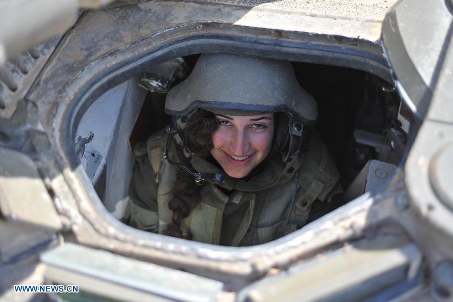 A female soldier of Israel Defense Forces (IDF)'s Shiryon (tank corps) unit takes part in a shooting training at Shizafon Armor Corps Training Base, south Israel, March 7, 2013 . These female soldiers will become instructors in Shiryon unit after finishing their 4-month training. (Xinhua/ Yin Dongxun)  
