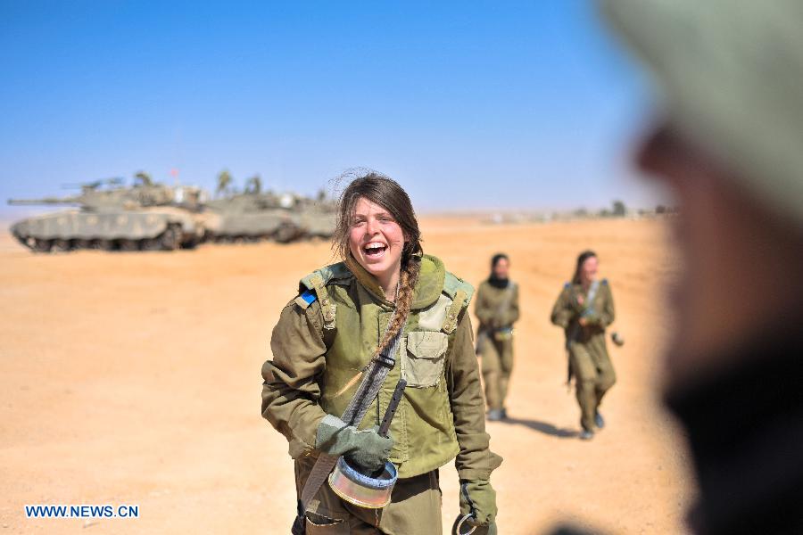 A female soldier of Israel Defense Forces (IDF)'s Shiryon (tank corps) unit takes part in a shooting training at Shizafon Armor Corps Training Base, south Israel, March 7, 2013 . These female soldiers will become instructors in Shiryon unit after finishing their 4-month training. (Xinhua/ Yin Dongxun) 