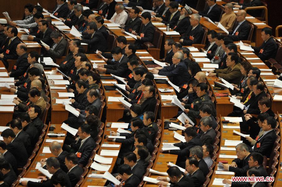 Members of the 12th National Committee of the Chinese People's Political Consultative Conference (CPPCC) listen at the third plenary meeting of the first session of the 12th CPPCC National Committee at the Great Hall of the People in Beijing, capital of China, March 8, 2013. (Xinhua/Guo Chen)