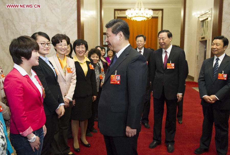 Xi Jinping (C), general secretary of the Central Committee of the Communist Party of China (CPC), talks with Chen Ruolin, the youngest deputy to the 12th National People's Congress (NPC), in Beijing, capital of China, March 8, 2013. Xi joined a discussion with deputies from east China's Jiangsu Province, who attend the first session of the 12th NPC, in Beijing on Friday. (Xinhua/Huang Jingwen)