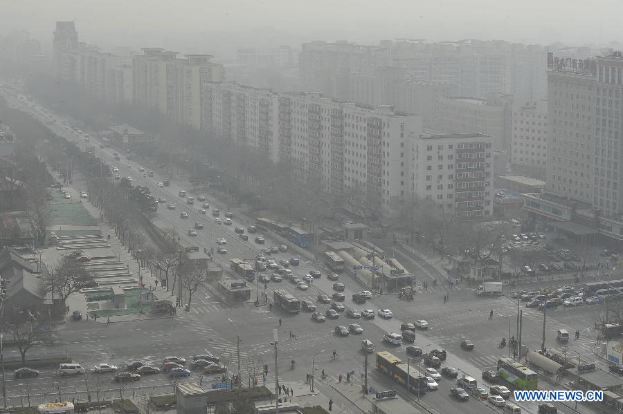 Motorcars run on a street in sandy air in Beijing, capital of China, March 9, 2013. A cold front brings strong wind as well as sand and dust to Beijing on March 9. (Xinhua/Lu Peng)