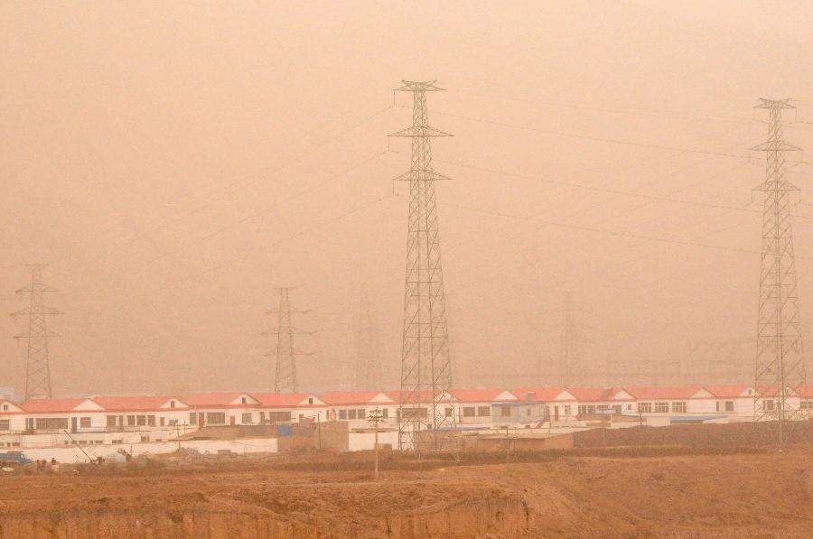 Buildings are blanketed by sand and dust in Yuzhong City of northwest China's Gansu Province, March 9, 2013. Sand and dust smothered multiple places in Gansu as a cold front brought strong wind to this region on March 9. (Xinhua/Fan Peishen)