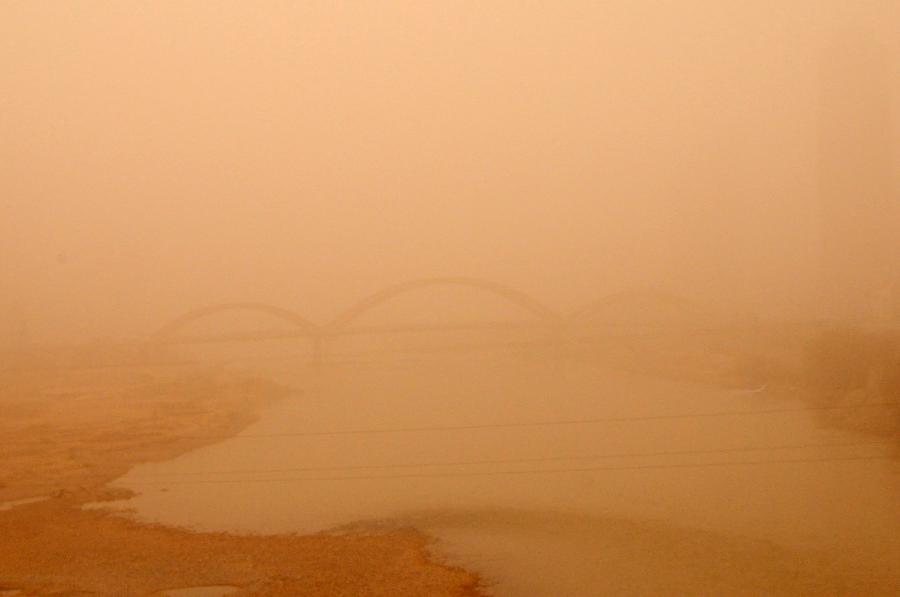 A bridge over the Yellow River is blanketed by sand and dust in Lanzhou, capital of northwest China's Gansu Province, March 9, 2013. Sand and dust smothered multiple places in Gansu as a cold front brought strong wind to this region on March 9. (Xinhua/Fan Peishen)