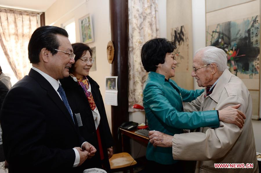 Member of the 12th National Committee of the Chinese People's Political Consultative Conference (CPPCC) Li Dongdong (2nd R) hugs with Sidney Shapiro at Shapiro's home in Beijing, capital of China, March 9, 2013. Members of the 12th CPPCC National Committee on Saturday visited the 98-year-old American-born translator Shapiro, a CPPCC member absent from the ongoing session due to poor physical condition. Shapiro was born in New York in 1915. He first came to China in 1947 and was granted Chinese citizenship in 1963. After the People's Republic of China was founded in 1949, Shapiro devoted himself to translating Chinese literature. He gained his reputation with his English translation of the Chinese classic "Outlaws of the Marsh". Shapiro also rounded off the English versions of modern Chinese literary works including "The Family" and "The Immense Forest and Snowfield." (Xinhua/Jin Liangkuai)