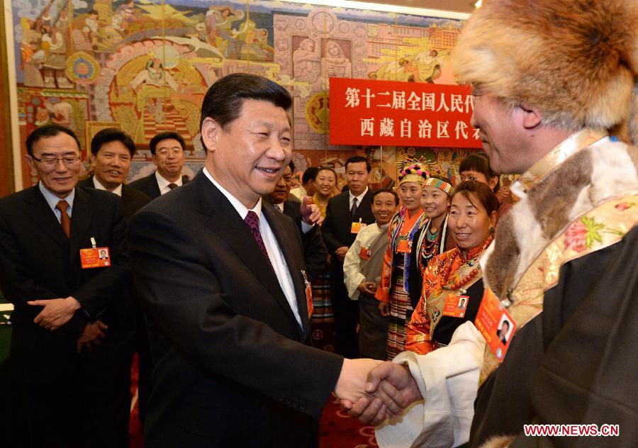 Xi Jinping (L front), general secretary of the Central Committee of the Communist Party of China (CPC), talks with a deputy to the 12th National People's Congress (NPC) from southwest China's Tibet Autonomous Region, in Beijing, capital of China, March 9, 2013. Xi joined a discussion with the Tibet delegation attending the first session of the 12th NPC in Beijing on Saturday. (Xinhua/Ma Zhancheng)