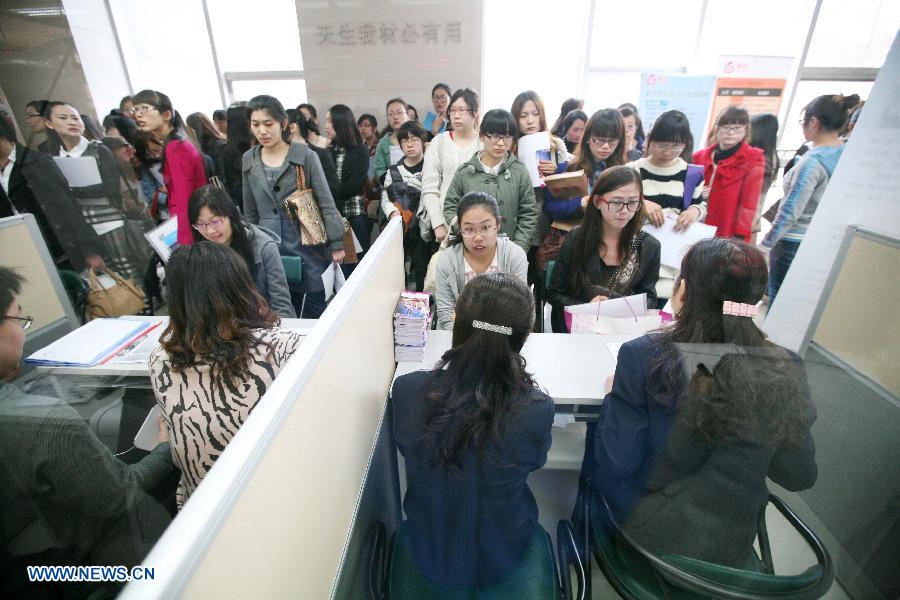 College students receive interviews at a job fair specially held for female graduates in Nanjing, capital of east China's Jiangsu Province, March 9, 2013. (Xinhua/Wang Xin)