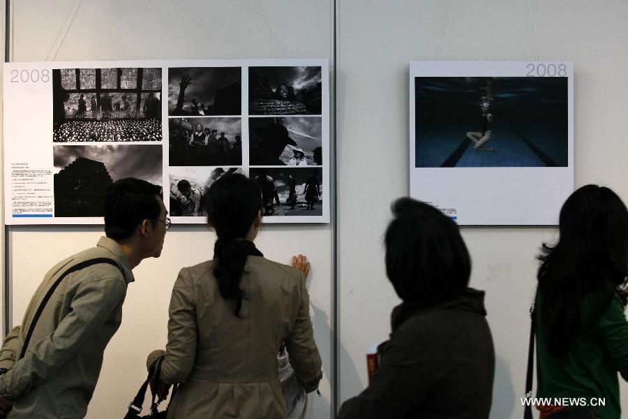 People visit a tour exhibition of the winning images of China International Press Photo Contest in the past years at the Wuxi Museum in Wuxi, east China's Jiangsu Province, March 9, 2013. (Xinhua/Sheng Guoping)