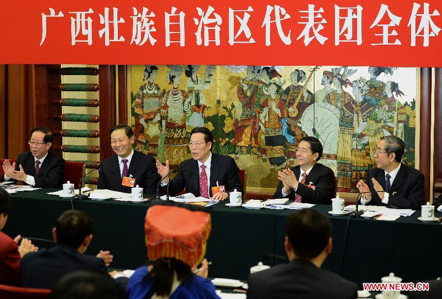 Zhang Gaoli (C), a member of the Standing Committee of the Political Bureau of the Communist Party of China (CPC) Central Committee, joins a discussion with deputies from south China's Guangxi Zhuang Autonomous Region, who attend the first session of the 12th National People's Congress (NPC), in Beijing, capital of China, March 10, 2013. (Xinhua/Liu Jiansheng) 