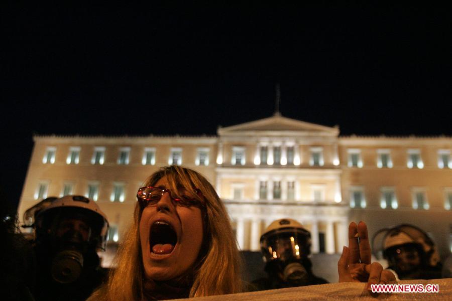 Greek indignant protesters clash with riot police in front of the Parliament in the Greek capital of Athens on March 10, 2013. About 500 indignant protesters come to Syntagma square to protest the harsh and painful austerity measures carried out by the government to counter debt crisis. (Xinhua/Marios Lolos) 