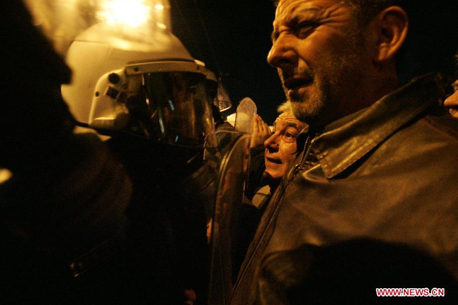 Greek indignant protesters clash with riot police in front of the Parliament in the Greek capital of Athens on March 10, 2013. About 500 indignant protesters come to Syntagma square to protest the harsh and painful austerity measures carried out by the government to counter debt crisis. (Xinhua/Marios Lolos) 