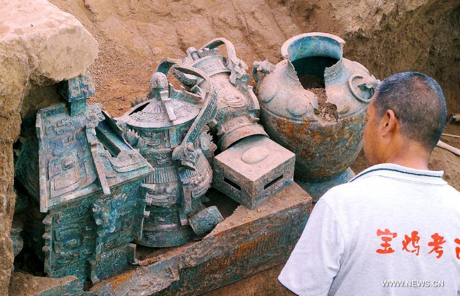 File photo taken on July 5, 2012 shows ancient bronze artifacts unearthed from the Shigushan Mountain of Baoji City, northwest China's Shaanxi Province. Archaeologists said Sunday that one piece of thigh armor and two pieces of upper-body armor dating back 3,000 years may be the oldest pieces of bronze armor ever unearthed in China. The announcement was made after experts studied the artifacts retrieved from the tomb of a nobleman from the West Zhou Dynasty (1046 BC - 771 BC) in Shigushan Mountain of Baoji City. Liu Junshe, head of the excavation team, said the discovery filled in a blank in China's early military history, as excavations of pieces of armor forged during or prior to the Qin Dynasty (221 BC - 206 BC) have been rare. (Xinhua/Feng Guo) 