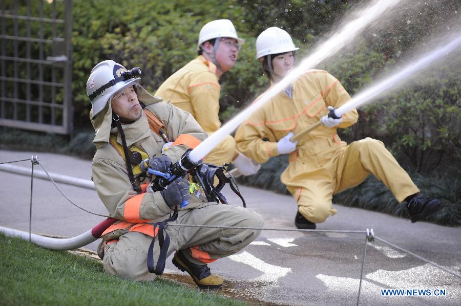 Fire fighters attend a drill in Tokyo, capital of Japan, on March 11, 2013. A drill to take precautions against natural calamities including medical emergency and fire fighting drills was held here to mark the two year anniversary of the March 11 earthquke and ensuing tsunami that left more than 19,000 people dead or missing and triggered a nuclear accident the world had never seen since 1986. (Xinhua/Kenichiro Seki) 