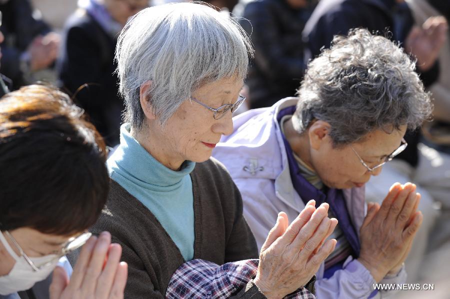 People attend a mourning ceremony in Tokyo, capital of Japan, on March 11, 2013. A mourning ceremony was held here Monday to mark the two year anniversary of the March 11 earthquke and ensuing tsunami that left more than 19,000 people dead or missing and triggered a nuclear accident the world had never seen since 1986. (Xinhua/Kenichiro Seki) 