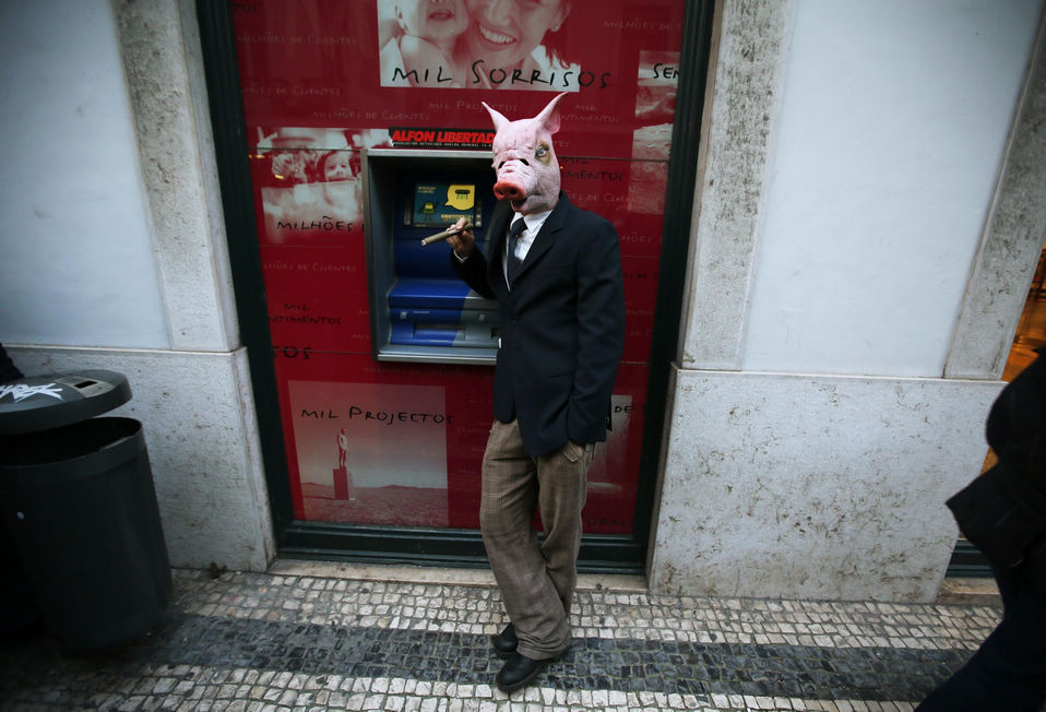 A protestor wearing a mask of a pig smokes during a march against government austerity policies in central Lisbon on March 2, 2013. Hundreds of thousands of Portuguese poured into the streets of Lisbon and other cities on Saturday to demand an end to austerity measures dictated by an international bailout and for the centre-right government to resign. (Xinhua News Agency/Reuter)