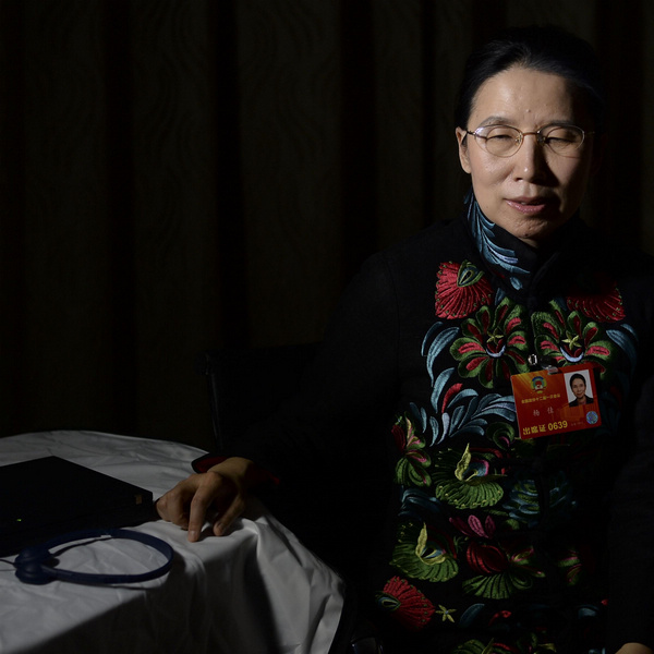 Yang Jia, a CPPCC National Committee member and Professor of the Chinese Academy of Science, poses with her computer and headphones in Beijing, on March 5, 2013. As a blind woman, she dreams that the disabled can participate in social activities just like normal people, using developments in technology. [Photo/Xinhua]