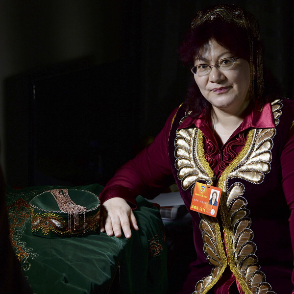 Fatima Mahmud, a lawyer and also a member of the CPPCC National Committee, poses with her Uzbek ethnic clothes on March 8, 2013. Fatima's dream concerns the protection and spread of the Uzbek ethnic group culture. Uzbeks have a population of 180,000 people, but a number of them under 50 cannot speak their own language. She has established an Uzbek cultural communication association in Xinjiang's Changcheng regions to protect and develop this minority culture. [Photo/Xinhua]