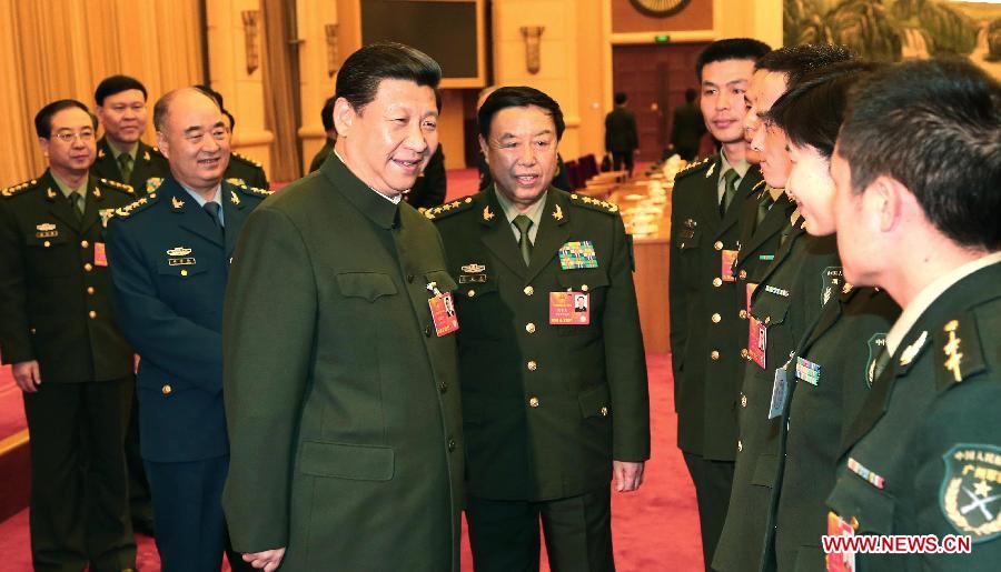 Xi Jinping, general secretary of the Central Committee of the Communist Party of China (CPC) and chairman of the CPC Central Military Commission, talks with deputies to the 12th National People's Congress (NPC) from the People's Liberation Army (PLA) in Beijing, capital of China, March 11, 2013. Xi attended a plenary meeting of PLA deputies who attend the first session of the 12th NPC, and delivered an important speech here on Monday. (Xinhua/Li Gang)