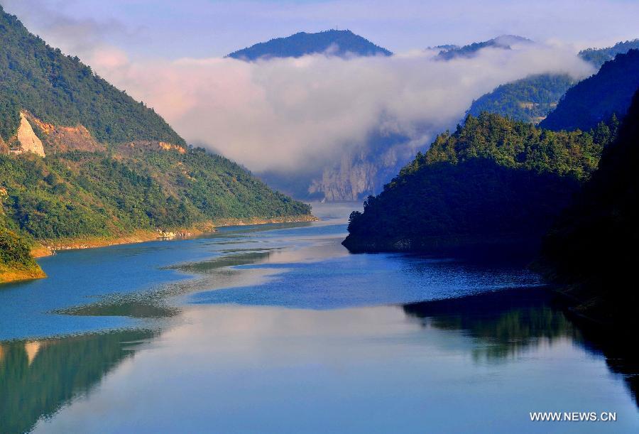 Photo taken on Oct. 18, 2012 shows the scenery of forest-covered mountains near Shuanglong Lake in Xuanen County of central China's Hubei Province. China's Arbor Day, or Planting Trees Day, which falls on March 12 each year, is an annual compaign to encourage citizens to plant and care for trees. (Xinhua/Song Wen)