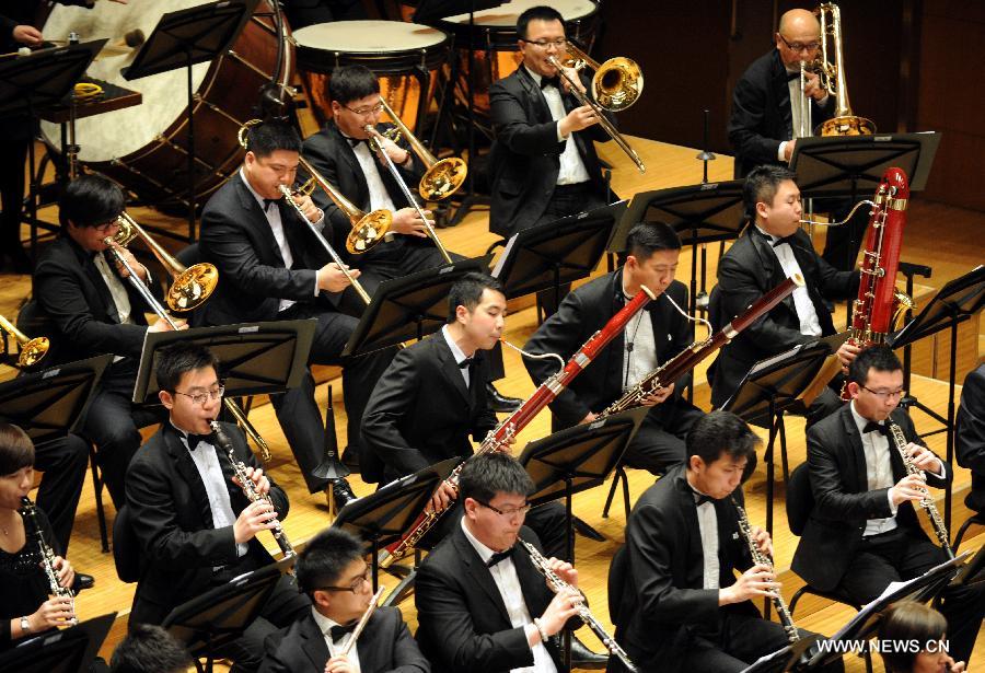 Musicians perform "Cavalleria Rusticana" at Beijing Concert Hall in Beijing, captial of China, March 11, 2013. The Beautiful Emotion concert presented by Zhejiang Symphony Orchestra and the military band of the People's Liberation Army was held here on Monday.(Xinhua/Wang Xiaochuan) 