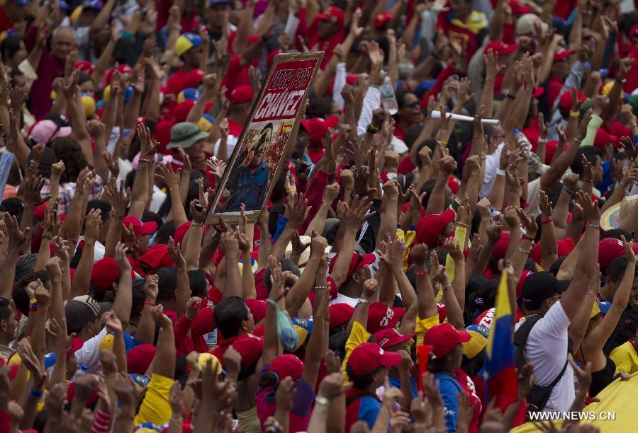 Supporters take part in a rally held after Venezuela's acting President Nicolas Maduro's official registration as candidate for presidential elections of April 14, outside the headquarters of the National Electoral Council of Venezuela in Caracas, capital of Venezuela, on March 11, 2013. (Xinhua/David de la Paz) 