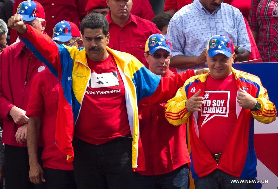 Venezuela's acting President Nicolas Maduro (L front) and Venezuelan Parliament President Diosdado Cabello (R front) take part in a rally held after his official registration as candidate for presidential elections of April 14, outside the headquarters of the National Electoral Council of Venezuela in Caracas, capital of Venezuela, on March 11, 2013. (Xinhua/Guillermo Arias) 