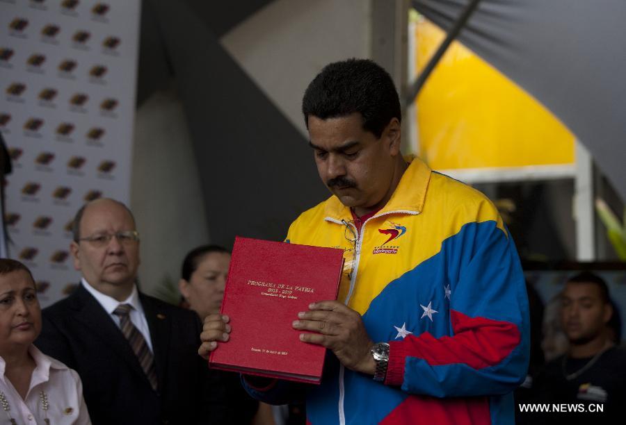 Venezuela's acting President Nicolas Maduro participates in a ceremony of his official registration as the ruling United Socialist Party of Venezuela (PSUV)'s candidate for presidential elections of April 14, at Venezuela's National Electoral Council (CNE) in Caracas, capital of Venezuela, on March 11, 2013. (Xinhua/Guillermo Arias) 