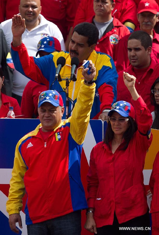 Venezuelan Parliament President Diosdado Cabello (L) takes part in a rally held after Venezuela's Acting President Nicolas Maduro's official registration as candidate for presidential elections of April 14, outside the headquarters of the National Electoral Council of Venezuela in Caracas, capital of Venezuela, on March 11, 2013. (Xinhua/Guillermo Arias) 