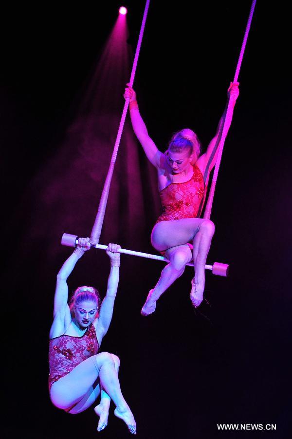Acrobats perform during the media preview of the circus show "Le Noir" held in the Marina Bay Sands Theatre in Singapore, March 12, 2013. The show with the theme of "Black, white and red" premieres in Singapore Tuesday. (Xinhua/Then Chih Wey) 