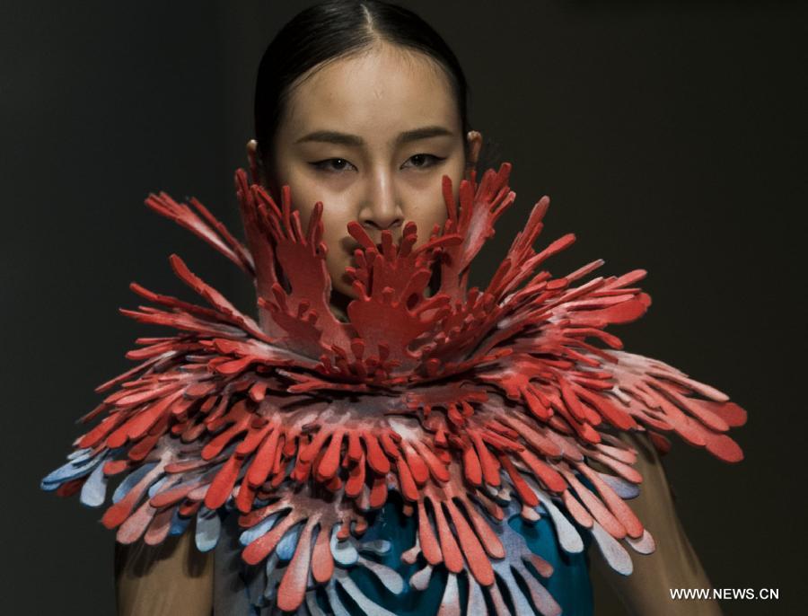 A model presents a creation of the 2013 graduates of Beijing Institute of Fashion Technology (BIFT) at the Institute's 2013 fashion week in Beijing, capital of China, March 12, 2013. The four-day fashion week of BIFT, China's premiere educational facility associated with fashion, kicked off on Tuesday. (Xinhua/Pan Songgang)