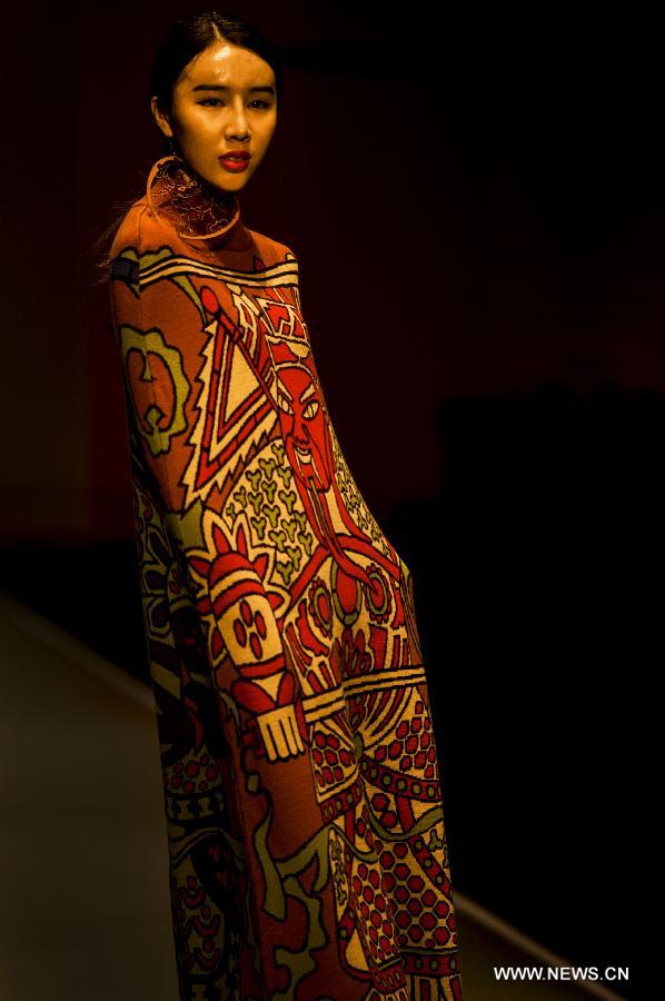 A model presents a creation of the 2013 graduates of Beijing Institute of Fashion Technology (BIFT) at the Institute's 2013 fashion week in Beijing, capital of China, March 12, 2013. The four-day fashion week of BIFT, China's premiere educational facility associated with fashion, kicked off on Tuesday. (Xinhua/Pan Songgang)