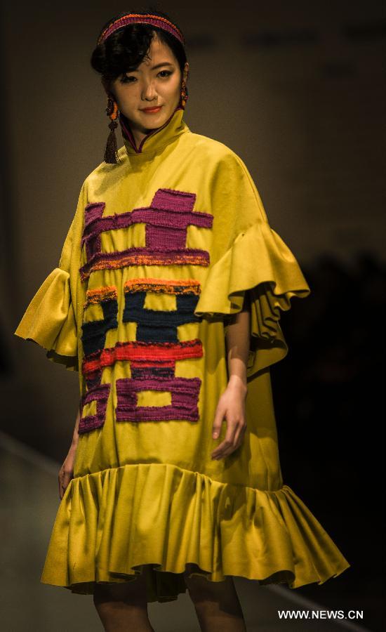 A model presents a creation of the 2013 graduates of Beijing Institute of Fashion Technology (BIFT) at the Institute's 2013 fashion week in Beijing, capital of China, March 12, 2013. The four-day fashion week of BIFT, China's premiere educational facility associated with fashion, kicked off on Tuesday. (Xinhua/Pan Songgang)