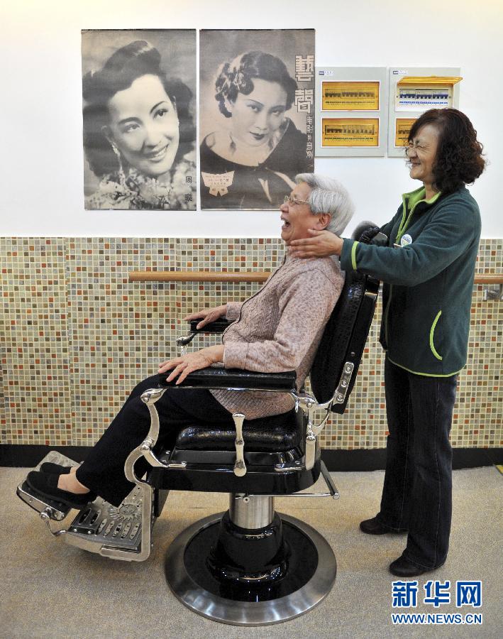 Elderly woman has a massage treatment at a senior day-care centre in Shanghai on April 10, 2012. (Xinhua/Niu Yixin )
