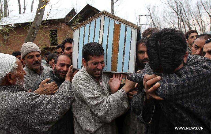 Relatives of a truck driver Riyaz Ahmad Khanday mourn over his death as they carry the coffin during his funeral procession at Matipora village in Anantnag district, 70km south of Srinagar, the summer capital of Indian-controlled Kashmir, March 12, 2013. A 23-year-old youth was killed after Indian army troopers opened gunfire on protesters in Baramulla town, around 55 km northwest of Srinagar city. The killing triggered massive anti-India protests and clashes in which Khanday was badly hurt and later died in a Srinagar hospital on Monday evening, police said. (Xinhua/Javed Dar)