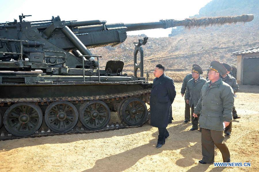 Photo released by KCNA news agency on March 12, 2013 shows Kim Jong Un (L), top leader of the Democratic People's Republic of Korea (DPRK), inspecting a long-range artillery sub-unit of Korean People's Army Unit 641, March 11, 2013. (Xinhua/KCNA)