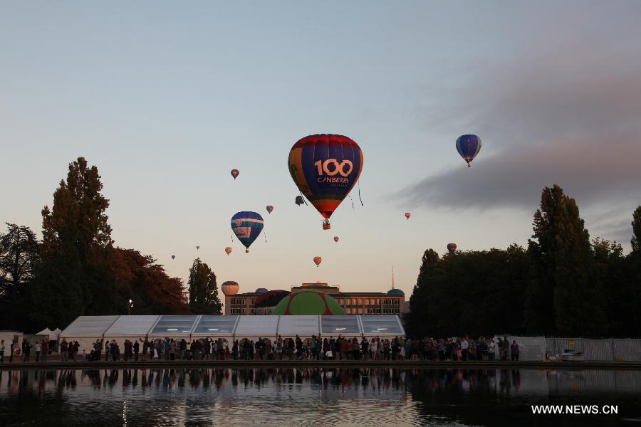 Hot air balloon float over Griffin Lake in Canberra, Australia, March 11, 2013. Canberra marked its 100th anniversary on Tuesday. (Xinhua/Qian Jun)  