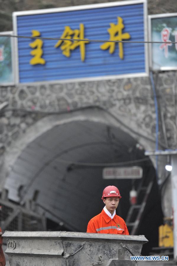 Photo taken on March 13, 2013 shows a rescuer at the site of the accident in Shuicheng County, southwest China's Guizhou Province. Twenty-one miners were killed and four others were missing in a coal and gas outburst Tuesday evening at Machang Coal Mine which belongs to Gemudi Company of Guizhou Water & Mining Group. Eighty-three miners were working underground when the accident took place, and 58 of them managed to get to the ground safely. (Xinhua/Ou Dongqu)