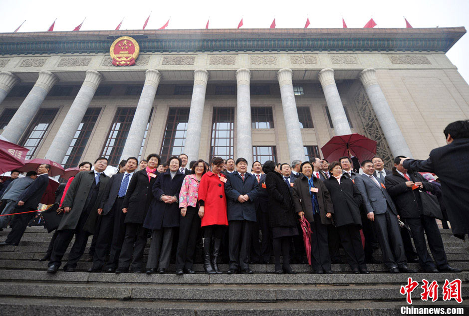 Delegates take photos together in front of the Great Hall of the People. (CNS/Jin Shuo)