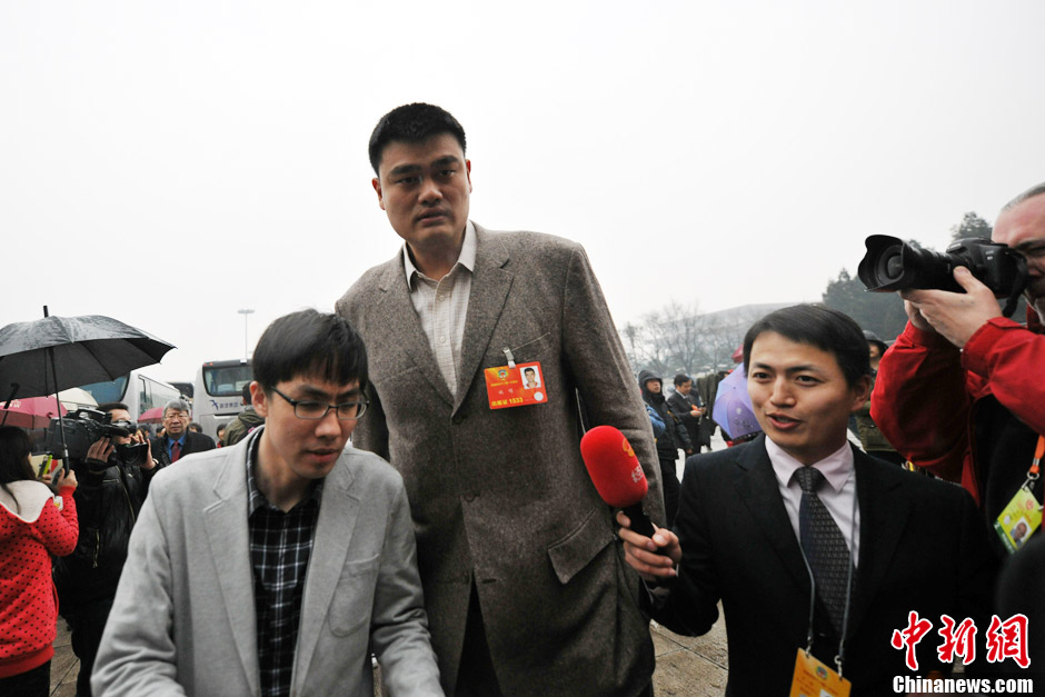Yao Ming, a retired Chinese professional basketball player who played for the Houston Rockets of the NBA, enters the Great Hall of the People in rain to attend the meeting. (CNS/Jin Shuo)