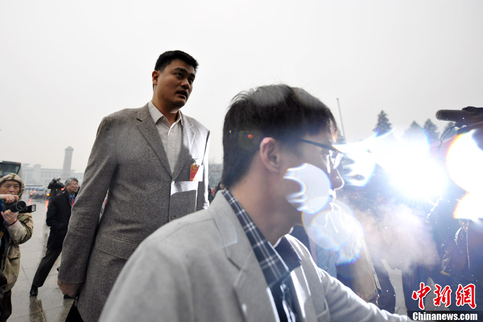 Yao Ming, a retired Chinese professional basketball player who played for the Houston Rockets of the NBA, enters the Great Hall of the People in rain to attend the meeting. (CNS/Jin Shuo)