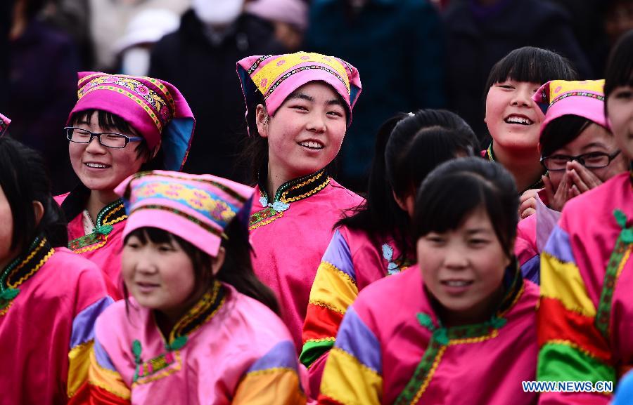 People from Tu ethnic group watch performance during a celebration for "Er Yue Er" in Tu Autonomous County of Huzhu, northwest China's Qinghai Province, March 13, 2013, on the occasion of the second day of the second lunar month, known in Chinese as Er Yue Er, "a time for the dragon to raise its head", as a Chinese saying goes. Local residents gathered together and celebrated the festival with traditional performance. (Xinhua/Zhang Hongxiang)  